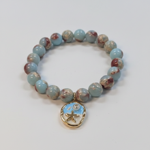 Load image into Gallery viewer, 10mm Light Aqua Terra Jasper with Ocean Blue Beach Scene Charm
